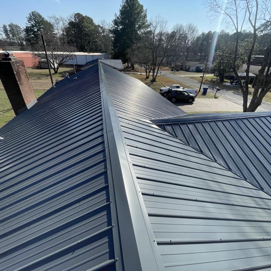 Finished dark standing-seam metal roof installed by RidgeTop Roofing and Repairs